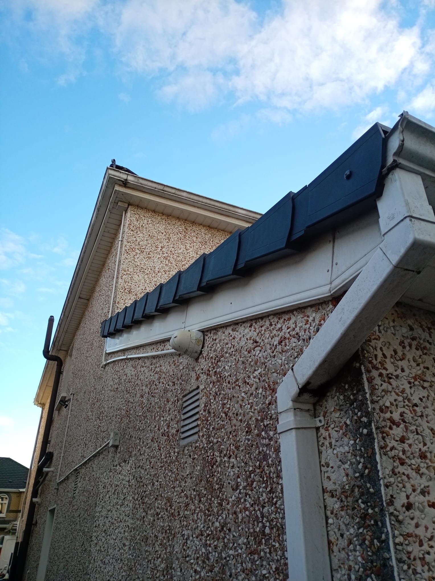 Grey dry verge covers fitted along the repaired extension roof edge in Clonsilla.