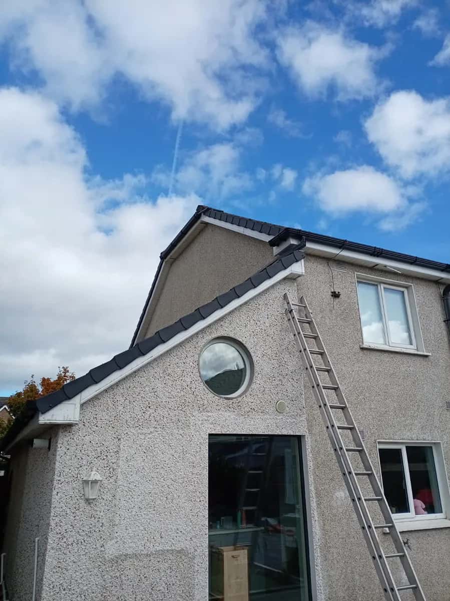Professional roofer installing a dry verge system on a Dublin 15 semi-detached home: clean, modern finish along the gable.